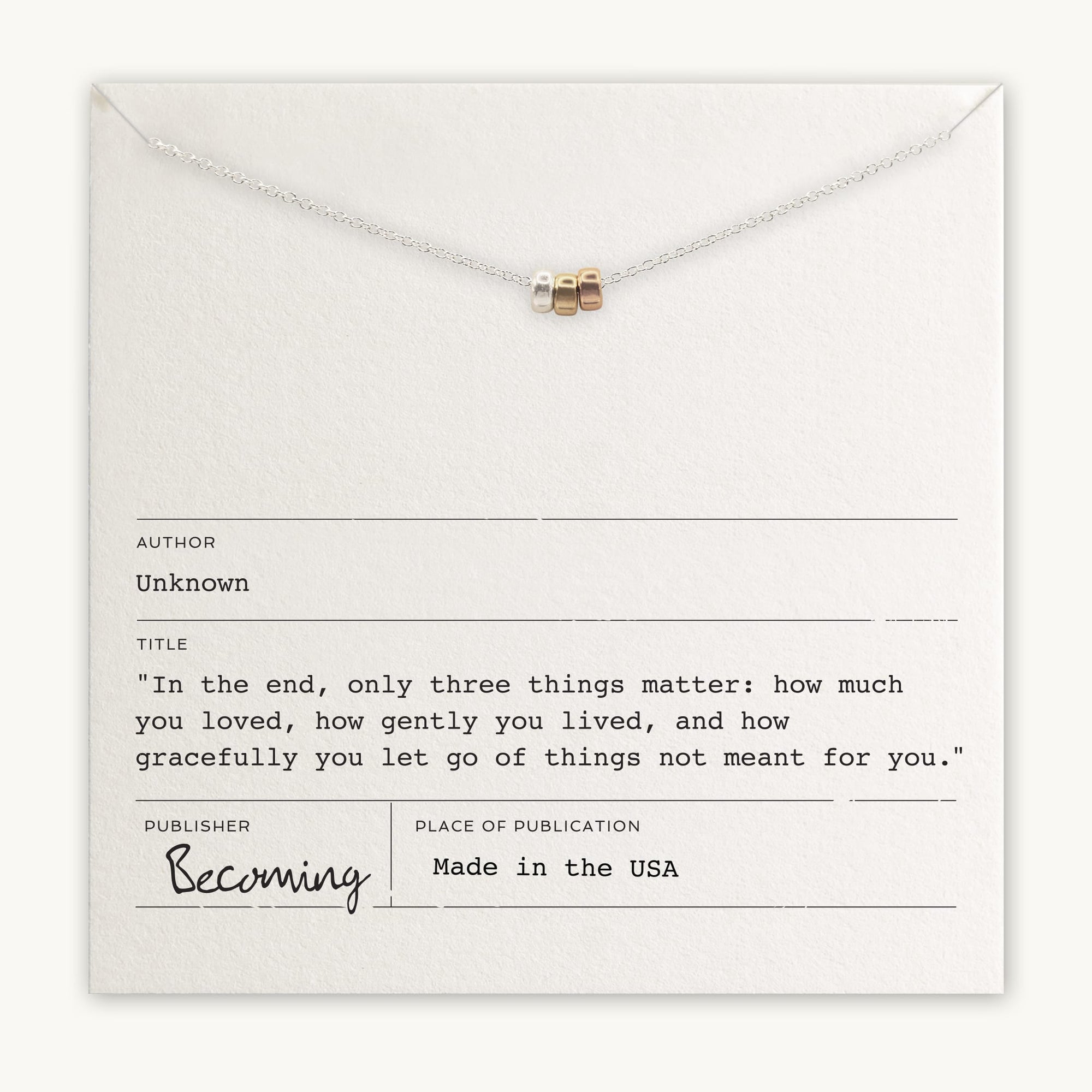 Close-up of a card showcasing the Three Things Necklace from Becoming Jewelry, featuring three rings and an inspirational quote: "In the end, only three things matter: how much you loved, how gently you lived, and how gracefully you let go of things not meant for you." This message encourages embracing life with love and grace.
