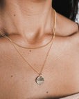 Woman wearing a delicate, Becoming Jewelry gold-filled Sea Necklace with a round pendant.