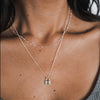 Close-up of a woman wearing a Becoming Jewelry Hidden Treasures Necklace.