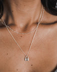 Close-up of a woman wearing a Becoming Jewelry Hidden Treasures Necklace.