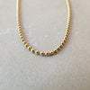 Becoming Jewelry Gold Filled Bead Chain Necklace on a gray background.