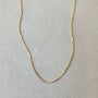 Becoming Jewelry's Gold filled box chain necklace on a plain background.