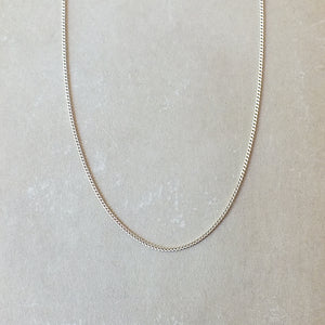 A Becoming Jewelry sterling silver curb chain necklace displayed on a neutral background.