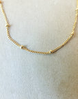 Satellite Chain Necklace by Becoming Jewelry on a white surface.