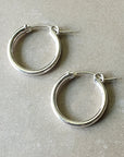 A pair of Becoming Jewelry Everyday Hoop Earrings, large on a gray background.