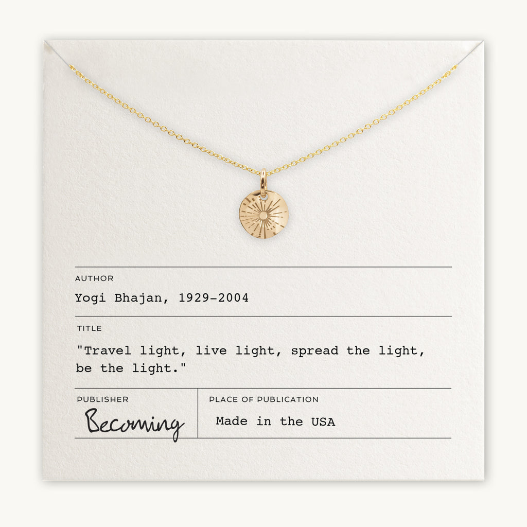 Becoming Jewelry's Be The Light Necklace, a sterling silver necklace with sunshine charm pendant, displayed on a card with an inspirational quote by Yogi Bhajan.