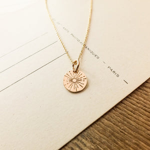 Be The Light Necklace gold filled pendant on a piece of paper with printed text by Becoming Jewelry.