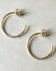 A pair of Large Open Hoop Earrings by Becoming Jewelry on a white background.