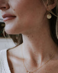 Model wearing lightly hammered simple round earrings
