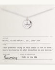 The Arrow Necklace, crafted by Becoming Jewelry, features a silver chain with a circular pendant and an arrow charm. It is presented on an off-white card adorned with an inspiring quote by Oliver Wendell Holmes, Sr., indicating that the product is made in the USA.