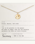 Becoming Jewelry's Blossom Necklace with a pendant displayed on a card featuring a quote by Marcel Proust about gratitude and happiness.