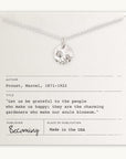 The Blossom Necklace by Becoming Jewelry features a pendant with a blossoming flowers design, beautifully displayed on a card bearing an inspiring quote from Marcel Proust about being grateful to those who make us happy. Proudly made in the USA.