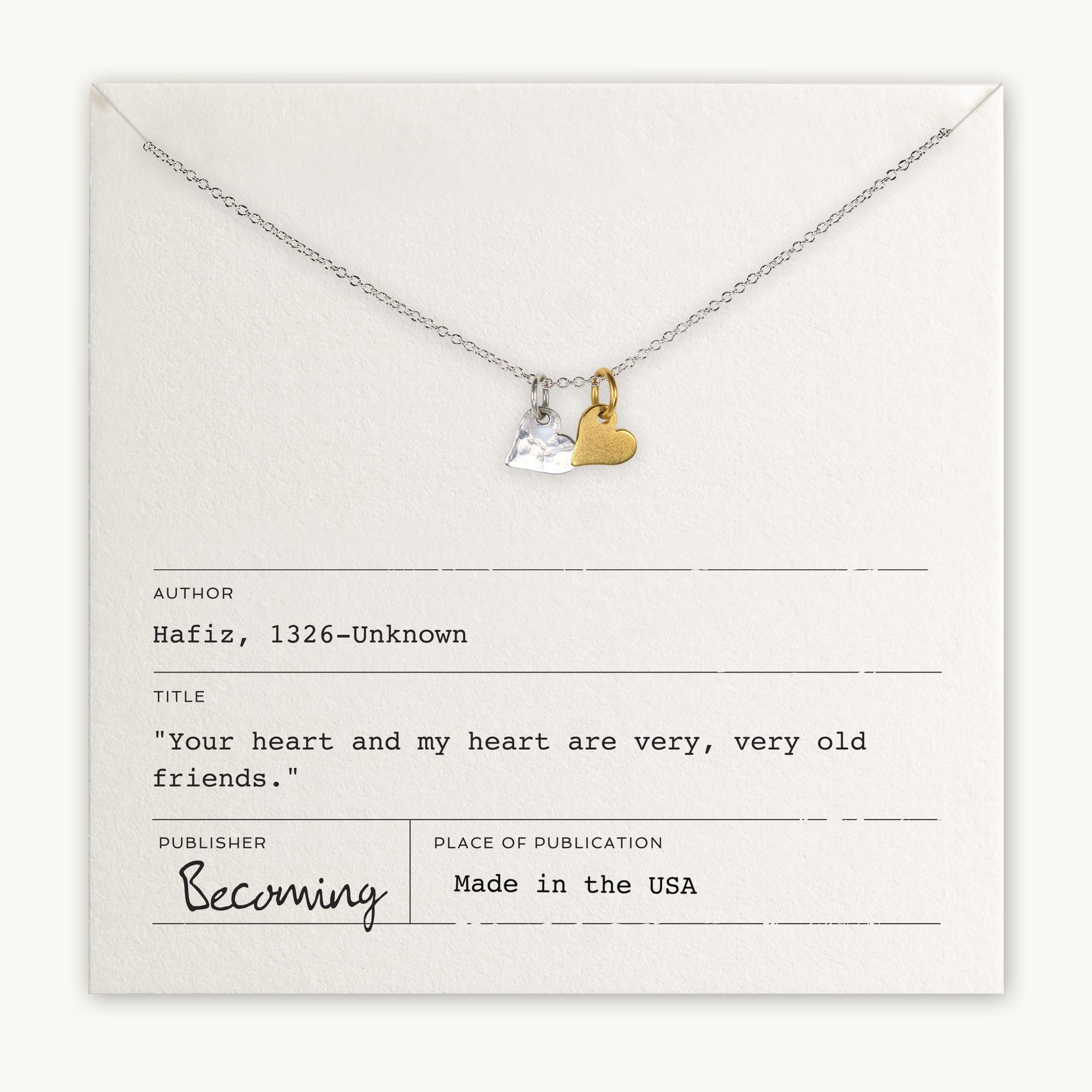 A Tiny Hearts Necklace by Becoming Jewelry, featuring mixed metal hearts, beautifully displayed on a card with a quote from Hafiz. The card includes the author, title, publisher, and publication details.