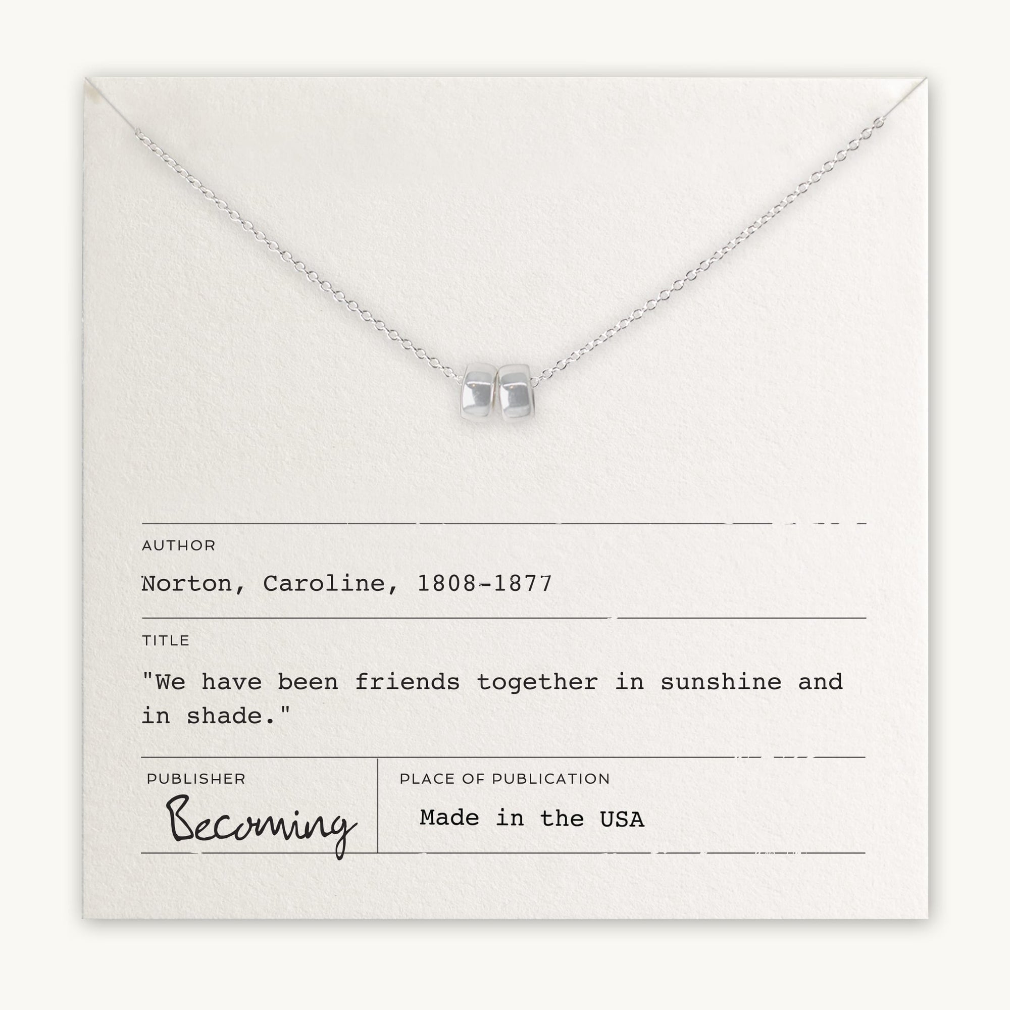 A Friends Beads Necklace by Becoming Jewelry is displayed on an envelope with text listing author Caroline Norton, title "We have been friends together in sunshine and in shade," and publisher Becoming. Made in the USA, this piece serves as a meaningful gift celebrating dearest friends.