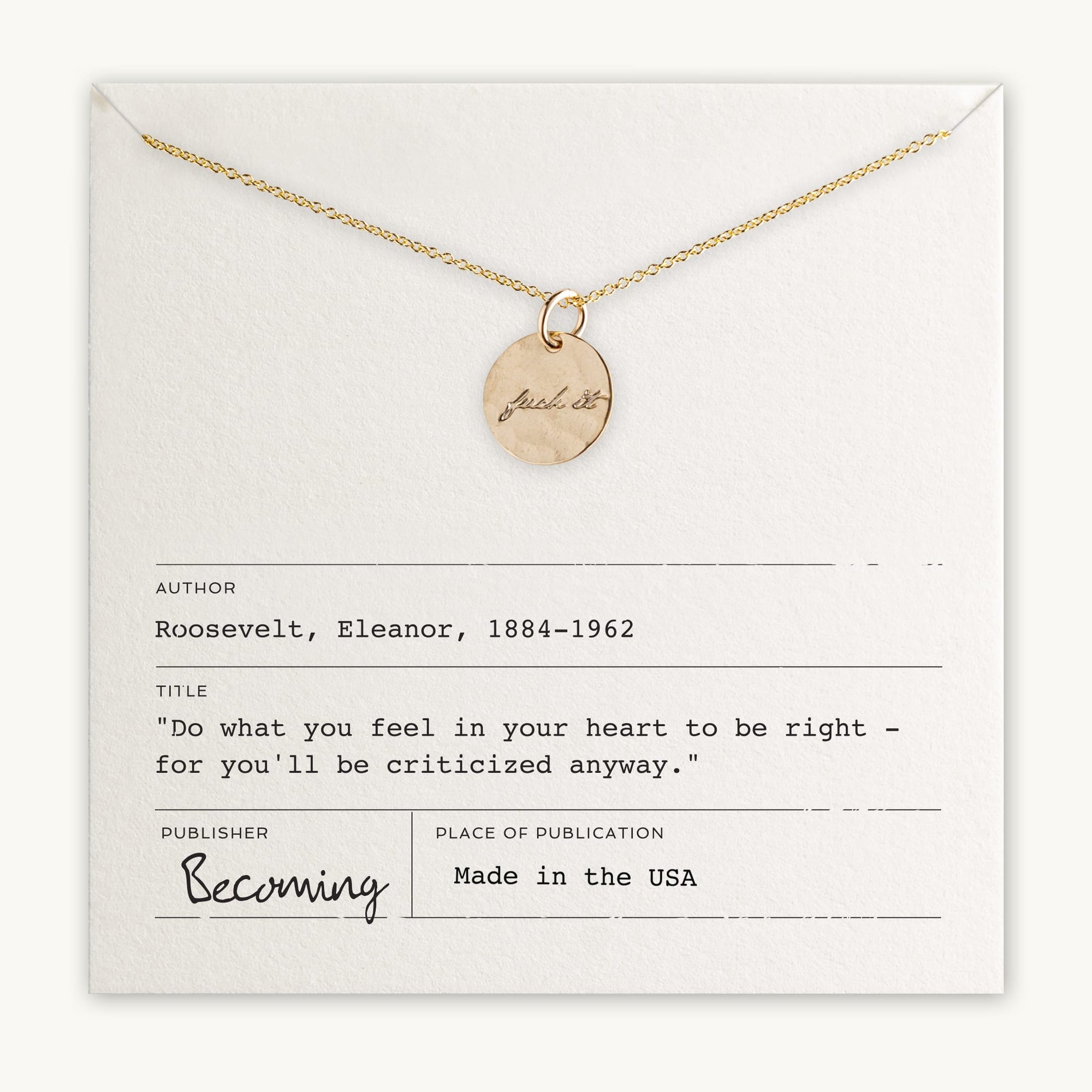 The "Fuck It Necklace" by Becoming Jewelry features a gold necklace with a small round charm engraved in an antique handwriting font that reads "Just Breathe," and is elegantly displayed on a card. The card attributes an inspiring quote to Eleanor Roosevelt and mentions the publication "Becoming." This piece is proudly made in the USA.