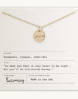 The "Fuck It Necklace" by Becoming Jewelry features a gold necklace with a small round charm engraved in an antique handwriting font that reads "Just Breathe," and is elegantly displayed on a card. The card attributes an inspiring quote to Eleanor Roosevelt and mentions the publication "Becoming." This piece is proudly made in the USA.