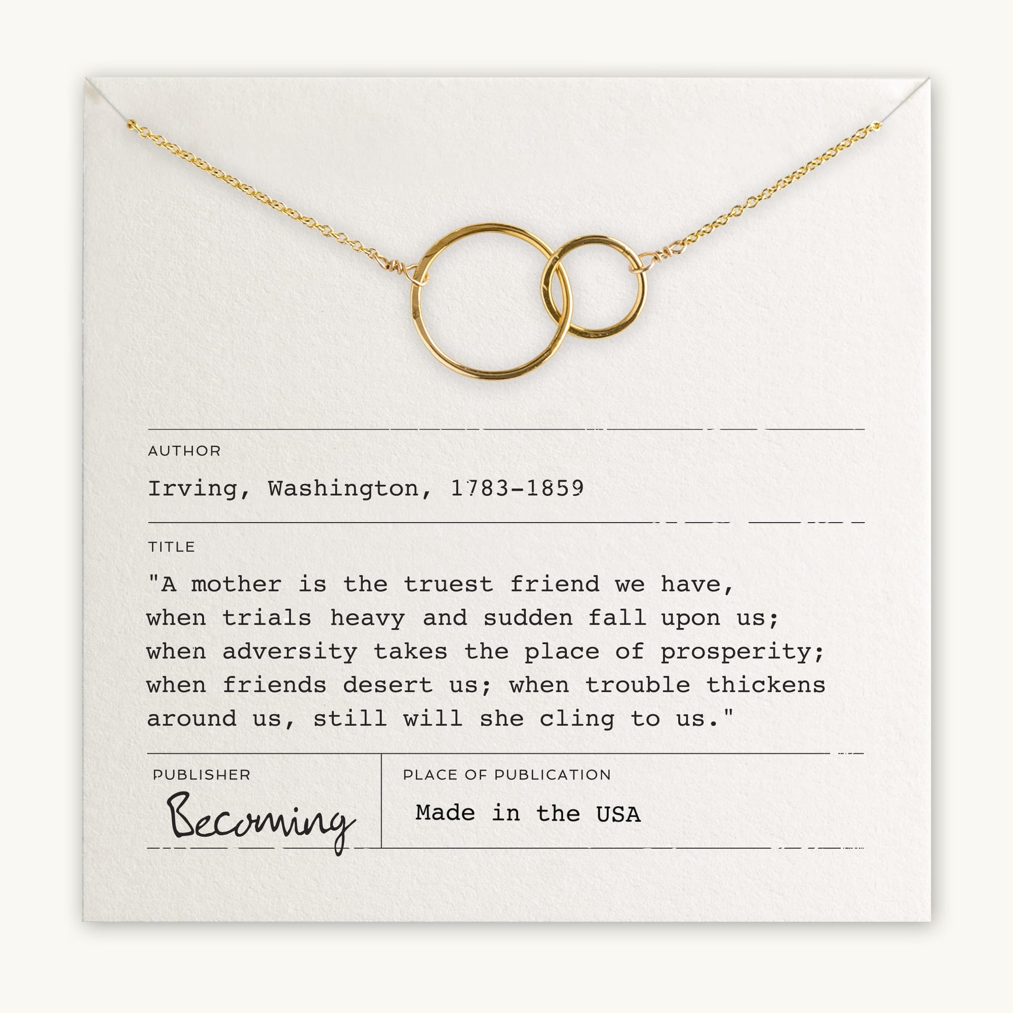 Becoming Jewelry's Mother Necklace, featuring gold interlinked rings, is elegantly displayed on a card with a touching quote about mothers by Washington Irving (1783-1859). Made in the USA, this piece beautifully symbolizes a mother's love and that special relationship.