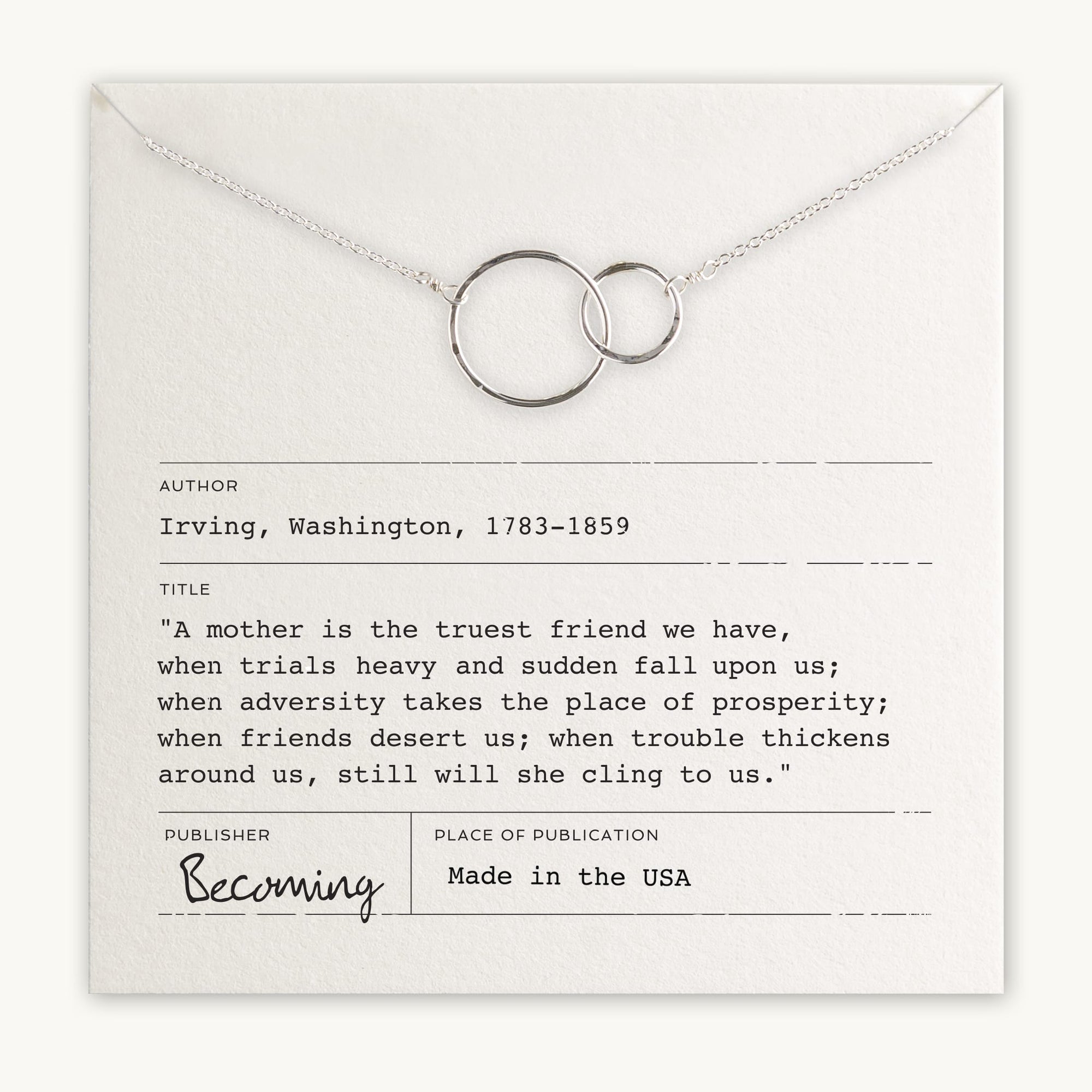 Becoming Jewelry&#39;s silver Mother Necklace with interlocking rings is laid on a card featuring a quote by Washington Irving.