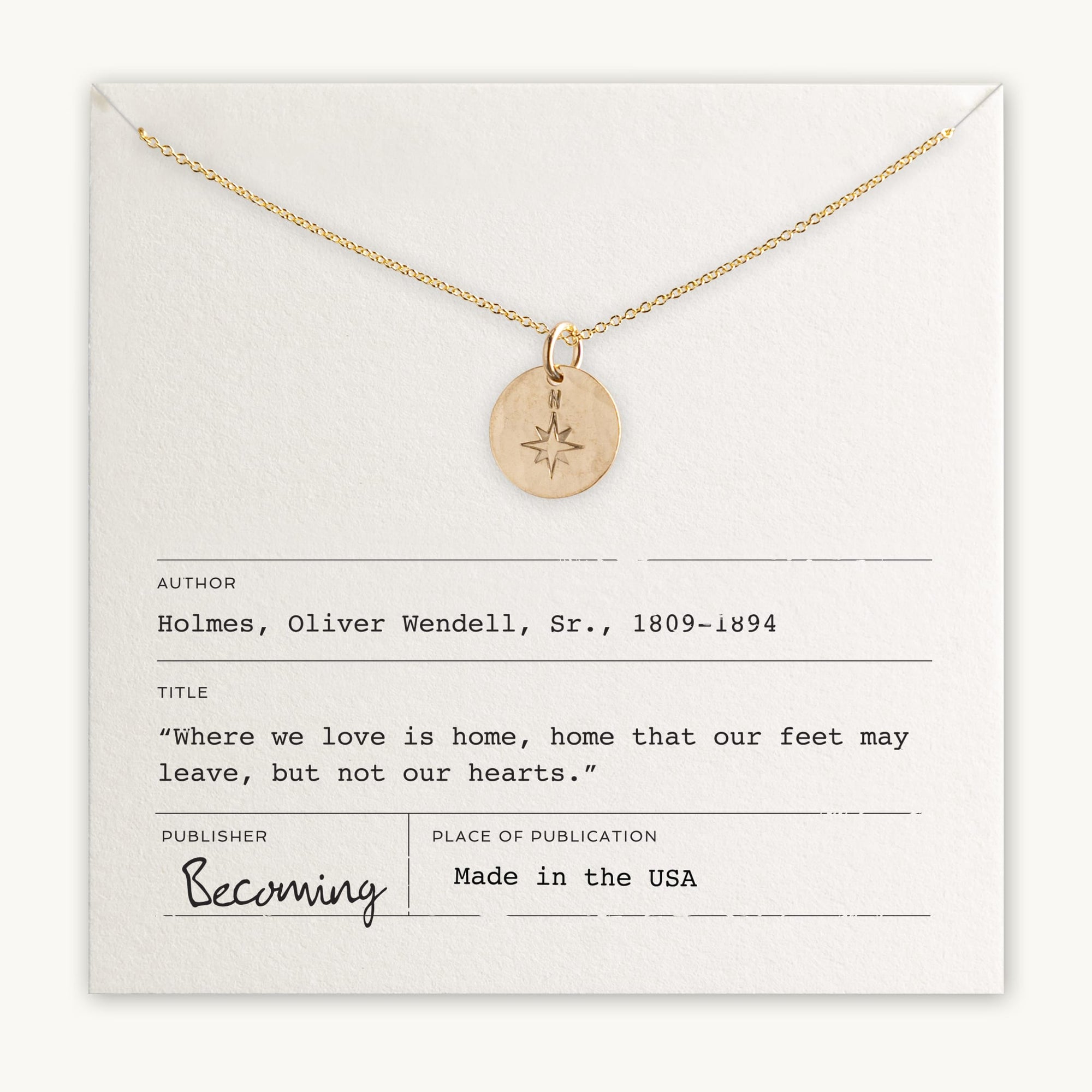 The North Star Necklace by Becoming Jewelry features a gold star pendant and is beautifully displayed on a card. The card showcases an inspiring quote by Oliver Wendell Holmes, Sr. about home and love, indicating it is made in the USA by "Becoming Jewelry." It's an ideal gift for travelers embarking on new adventures.