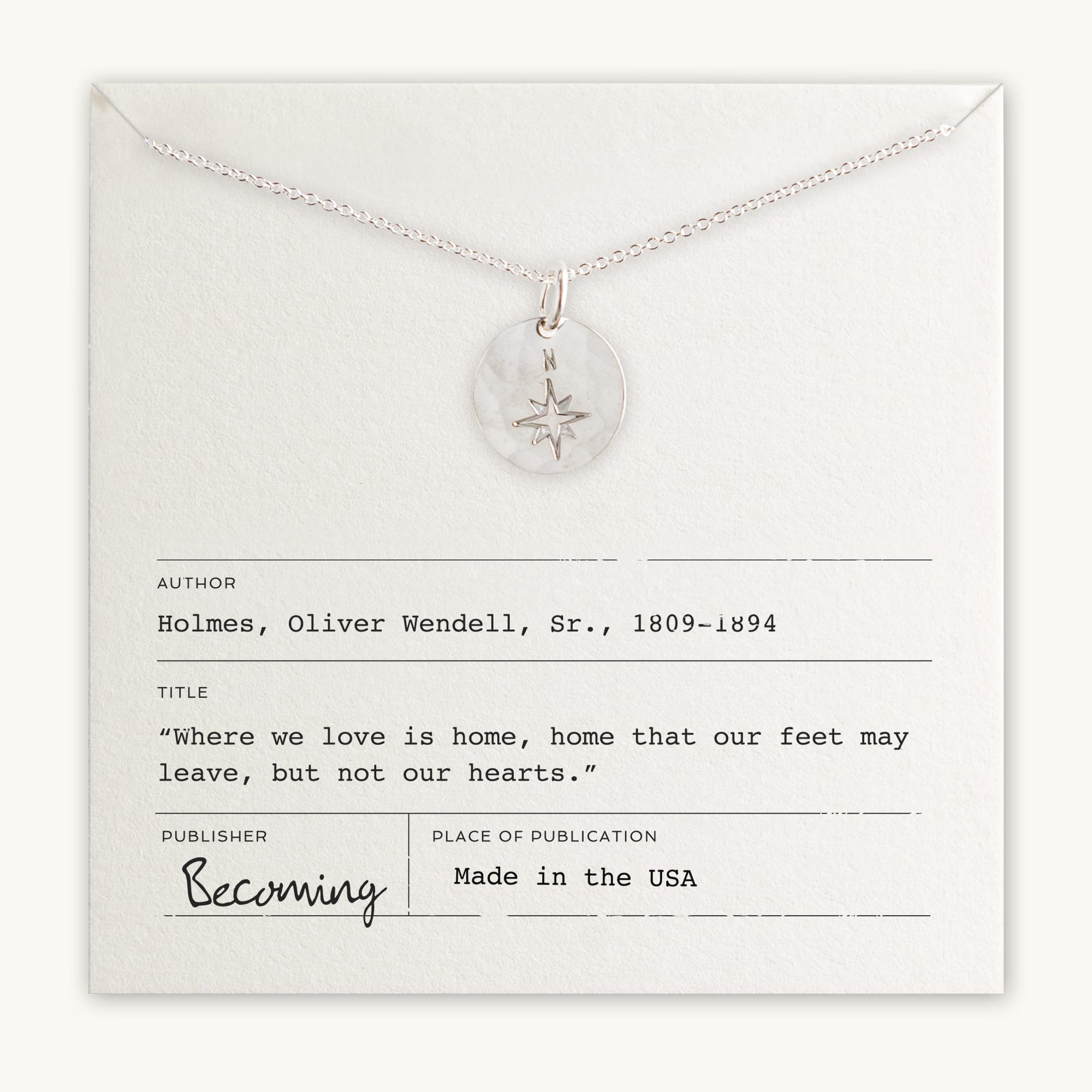 The North Star Necklace by Becoming Jewelry features a pendant with a compass charm, elegantly displayed over a card that includes an inspiring quote by Oliver Wendell Holmes Sr. The card also notes the author and the place of publication "Made in the USA." This necklace makes an exceptional gift for travelers or graduates.