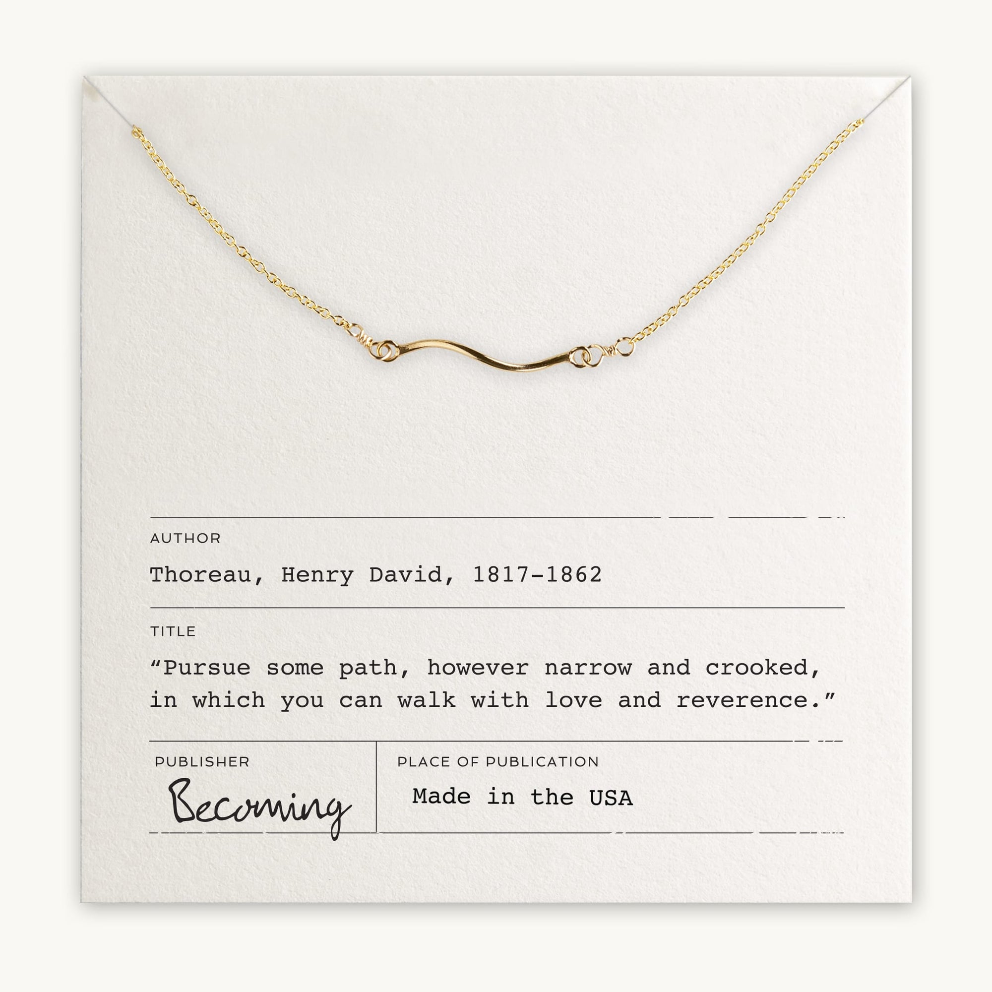 Becoming Jewelry&#39;s Path Necklace with a curved path charm displayed on a card with a quote by Henry David Thoreau.