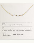 Becoming Jewelry's Path Necklace with a curved path charm displayed on a card with a quote by Henry David Thoreau.