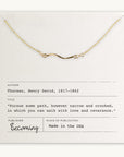 The Path Necklace by Becoming Jewelry, a minimalist gold necklace presented on a note that features an inspiring quote by Henry David Thoreau: “Pursue some path, however narrow and crooked, in which you can walk with love and reverence.” This meaningful gift serves as a gentle reminder to always follow one's heart.