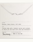 The Path Necklace, a beautiful silver accessory by Becoming Jewelry, features a wavy pendant and is displayed on a card with an inspiring quote by Henry David Thoreau. Made in the USA and published by Becoming, it offers a gentle reminder to follow one's heart, making it a meaningful gift.