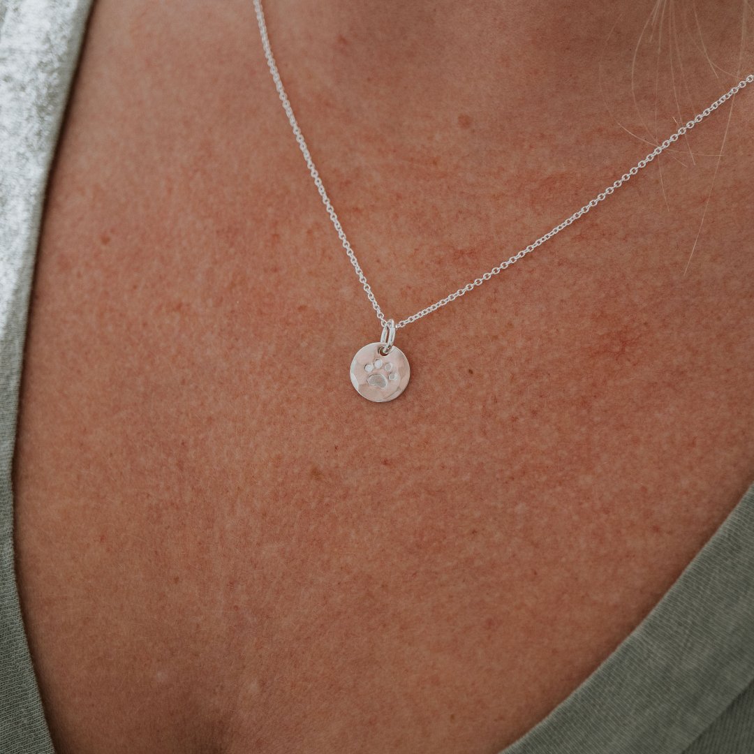paw print necklace on model