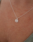 paw print necklace on model