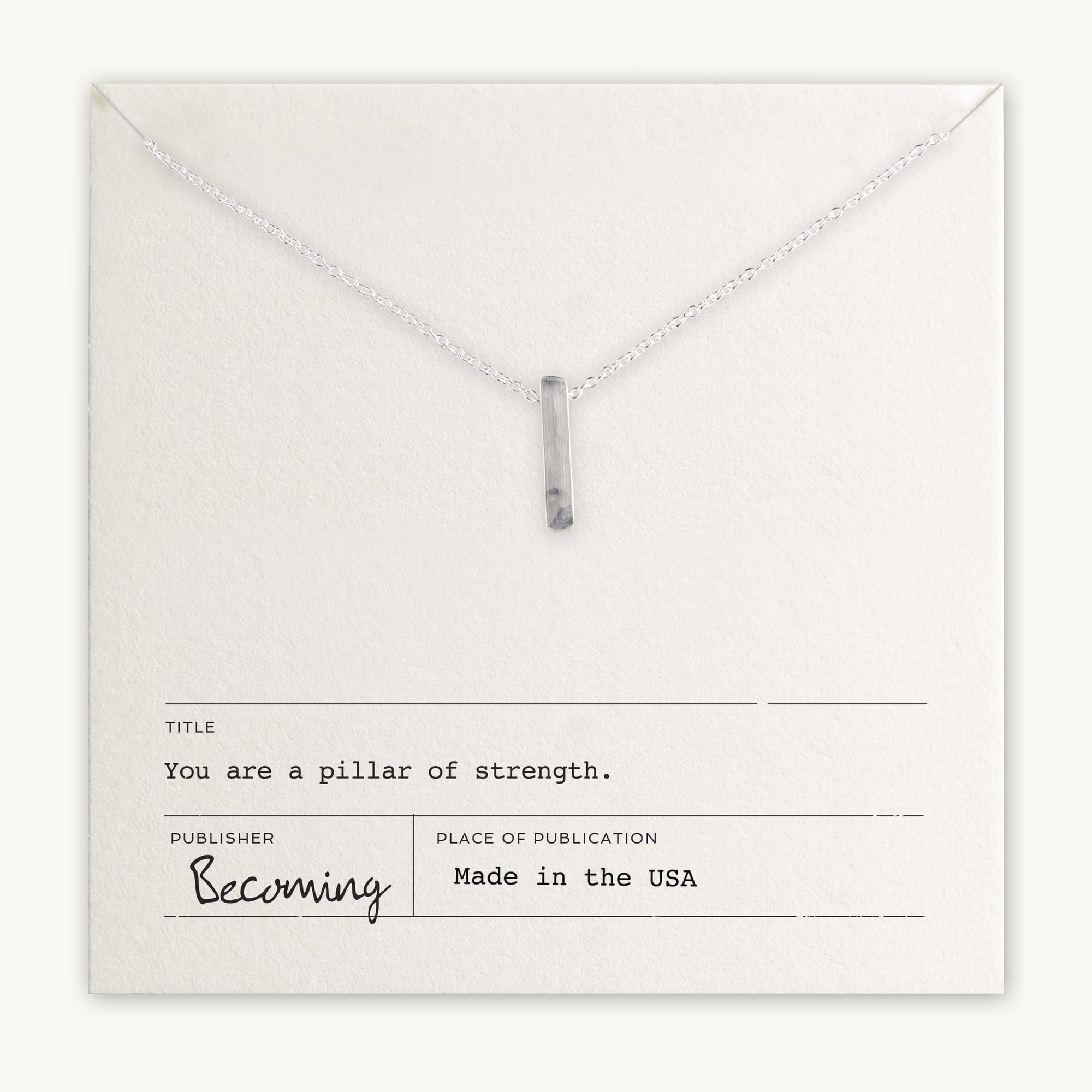 Becoming Jewelry&#39;s Pillar of Strength Necklace is a sterling silver necklace with a hammered bar drop charm on a fine cable chain, displayed on a card with the inspirational message, &quot;you are a pillar of strength.