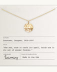 Introducing "The Sea Necklace" by Becoming Jewelry: a gold necklace adorned with a wave-patterned pendant, elegantly displayed on a card featuring Jacques Cousteau's inspiring quote, "The sea, once it casts its spell, holds one in its net of wonder forever." Proudly made in the USA, this ocean-inspired treasure makes an enchanting gift for anyone mesmerized by the magic of the sea.