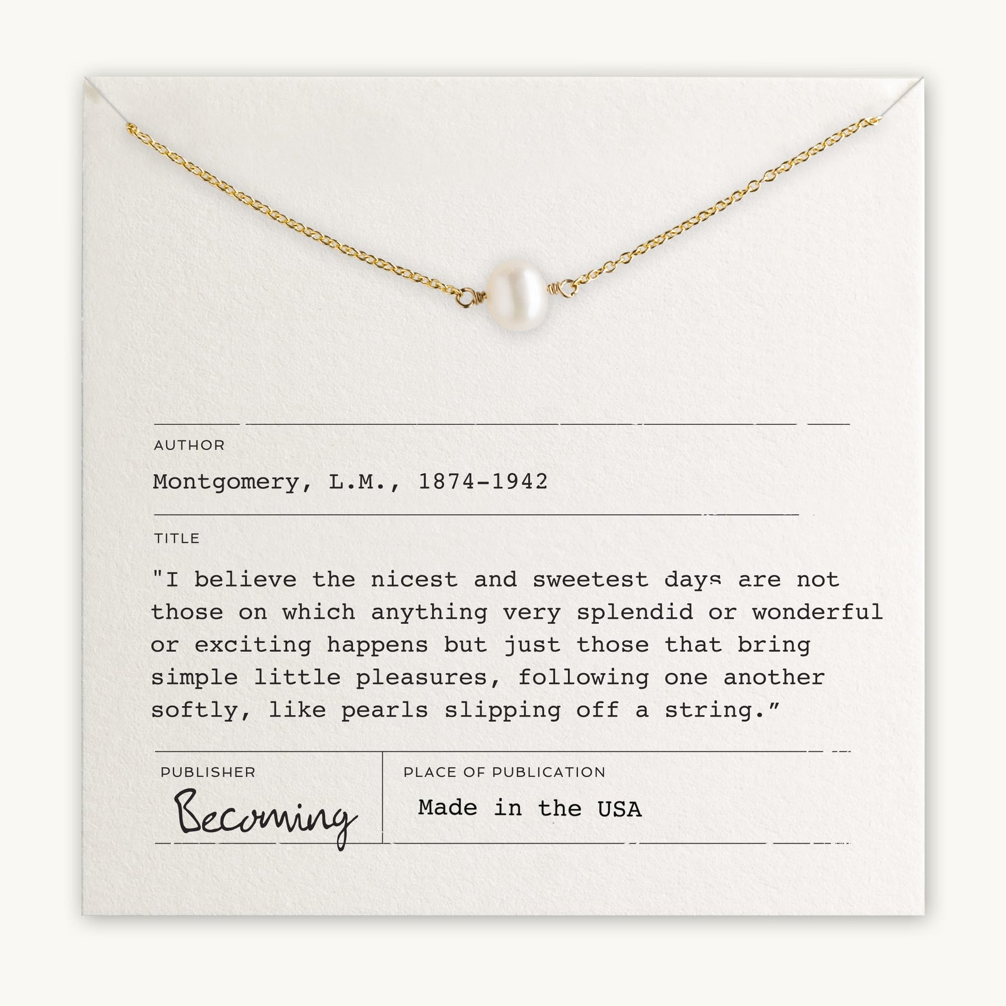 The Simple Pleasures Pearl Necklace by Becoming Jewelry features a delicate gold chain with a single pearl and is elegantly presented on a card that includes a quote by L.M. Montgomery, details about the author, and publication information. The design effortlessly captures timeless beauty.