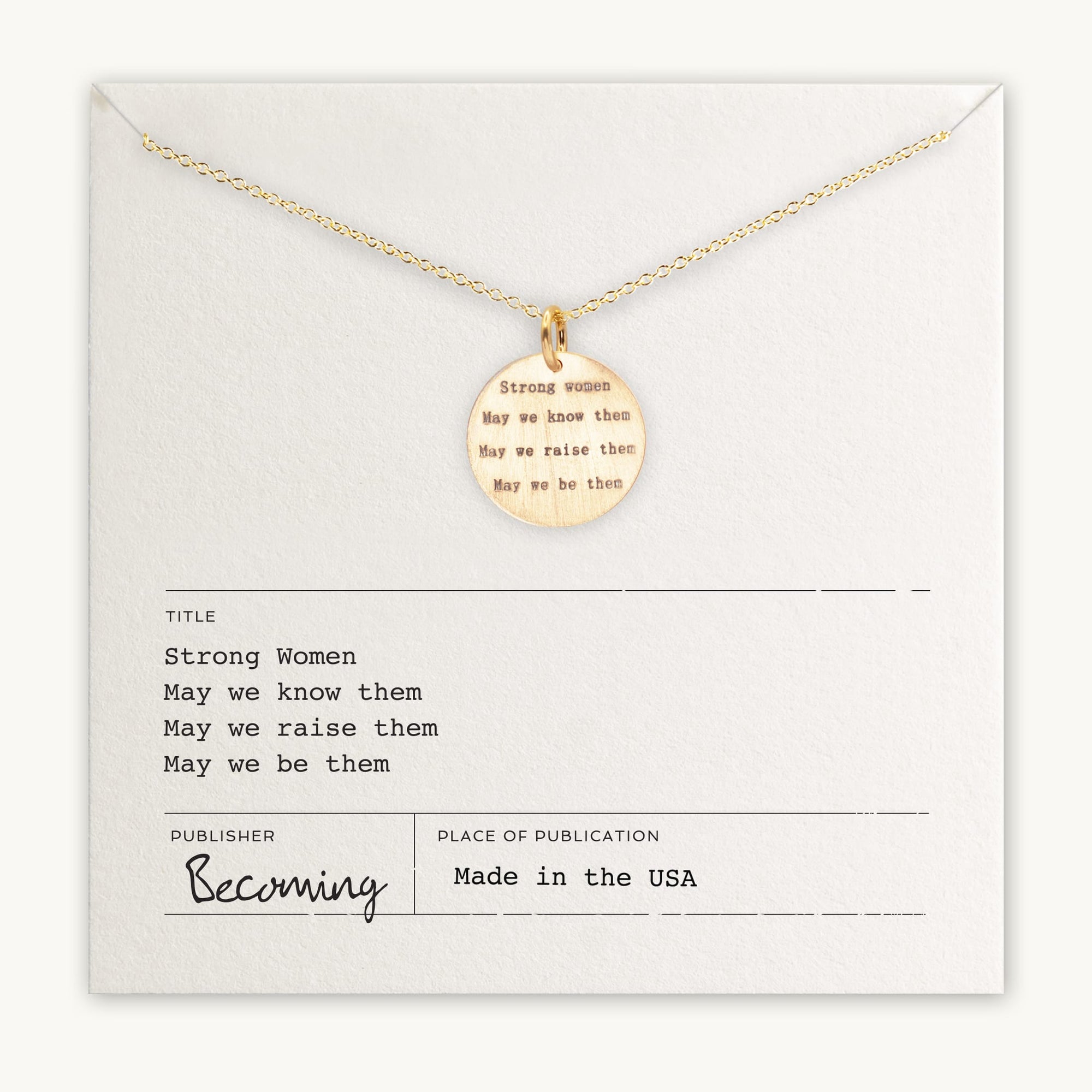 Strong Women Necklace with "Strong Women: May we know them, May we raise them, May we be them" inscribed. Displayed on a card with publication details and brand name "Becoming Jewelry" noted. Made in the USA, this necklace makes a thoughtful gift perfect for daily wear.
