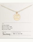 Strong Women Necklace with "Strong Women: May we know them, May we raise them, May we be them" inscribed. Displayed on a card with publication details and brand name "Becoming Jewelry" noted. Made in the USA, this necklace makes a thoughtful gift perfect for daily wear.
