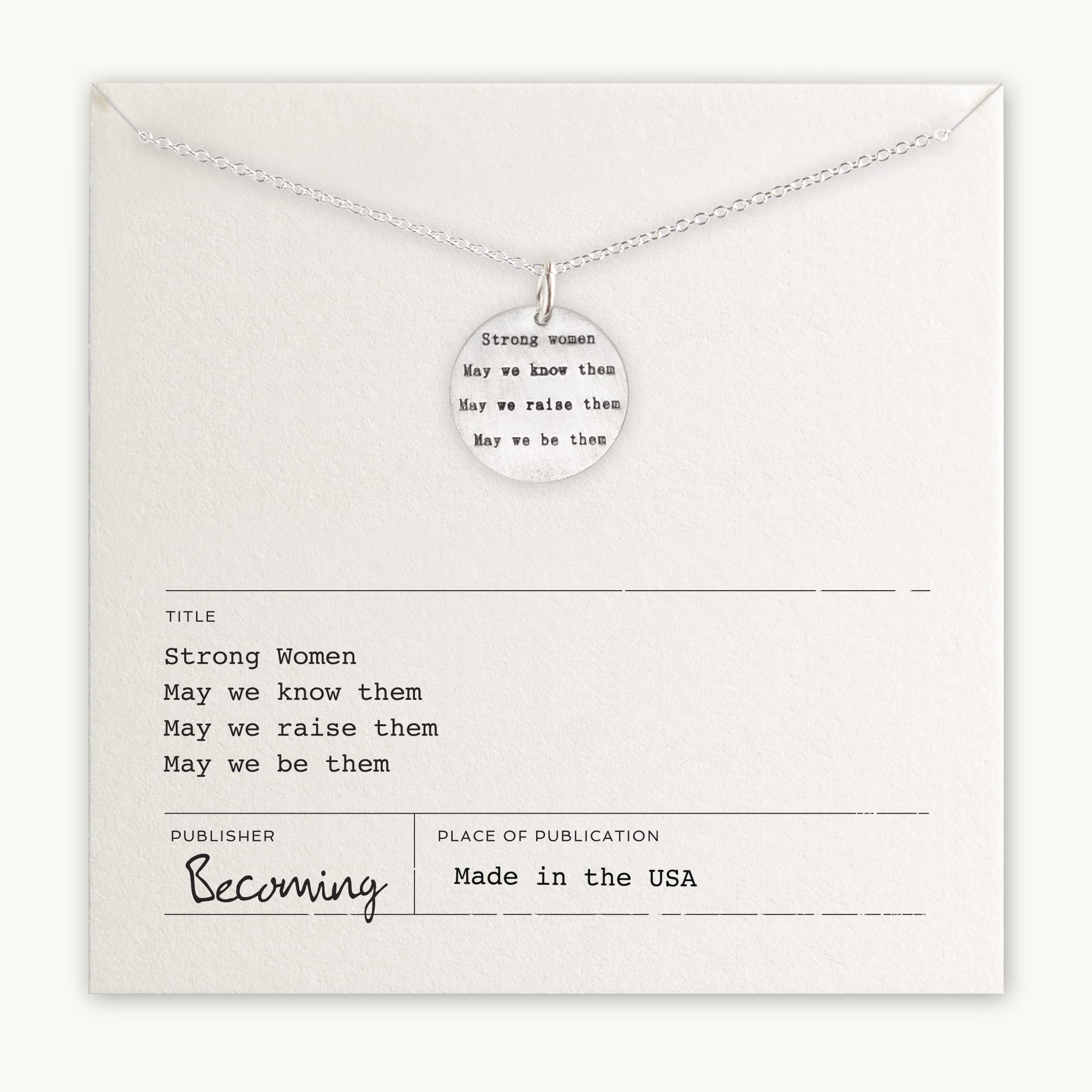 A thoughtful gift, the Strong Women Necklace by Becoming Jewelry showcases a circular pendant engraved with the empowering phrases "Strong Women, May we know them, May we raise them, May we be them." It is accompanied by a card featuring the same heartfelt message and publisher details. Ideal for daily wear to keep inspiration close.