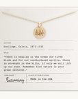 A gold Trees Necklace by Becoming Jewelry, featuring a pendant with engraved trees, is presented on a card that includes a quote by Calvin Coolidge about nature's restorative power. The card bears publication details from Becoming.