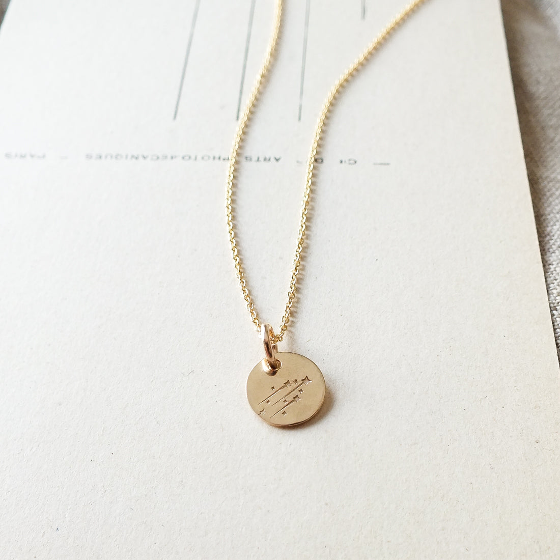 Becoming Jewelry&#39;s Believe in Magic Necklace with a shooting stars charm on a white background.