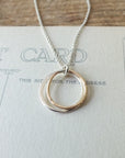 Friendship Circles Necklace by Becoming Jewelry with a circular pendant displayed on a message necklace card background.