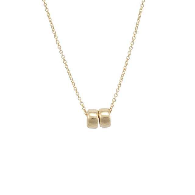 The Friends Beads Necklace from Becoming Jewelry is a gold necklace with a delicate chain and two small, polished gold bead pendants at the center, making it a meaningful gift for your dearest friends.