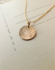 Irish Blessing necklace on a paper background by Becoming Jewelry.