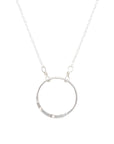 Silver circular Becoming Jewelry Wayne Dyer Charm pendant on a fine cable chain Karma Necklace against a white background.