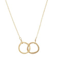 The Joined for Life Necklace by Becoming Jewelry showcases two interlinked geometric rings, symbolizing an unbreakable bond.