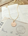 Badass Necklace by Becoming Jewelry displayed on vintage handwritten letters.