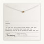 Close-up of a card showcasing the Three Things Necklace from Becoming Jewelry, featuring three rings and an inspirational quote: "In the end, only three things matter: how much you loved, how gently you lived, and how gracefully you let go of things not meant for you." This message encourages embracing life with love and grace.