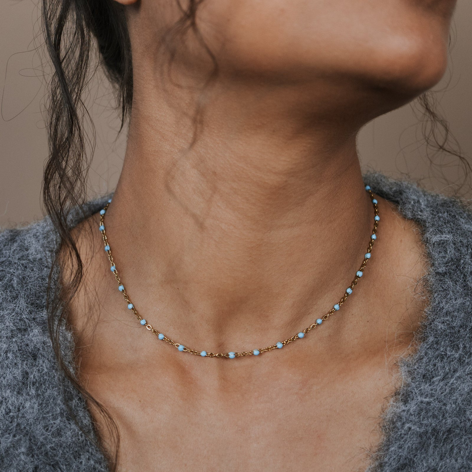 Woman wearing a turquoise beaded necklace
