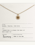 Necklace with sun-shaped pendant on a card with text