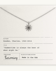 Necklace with sun-shaped pendant on a card with text