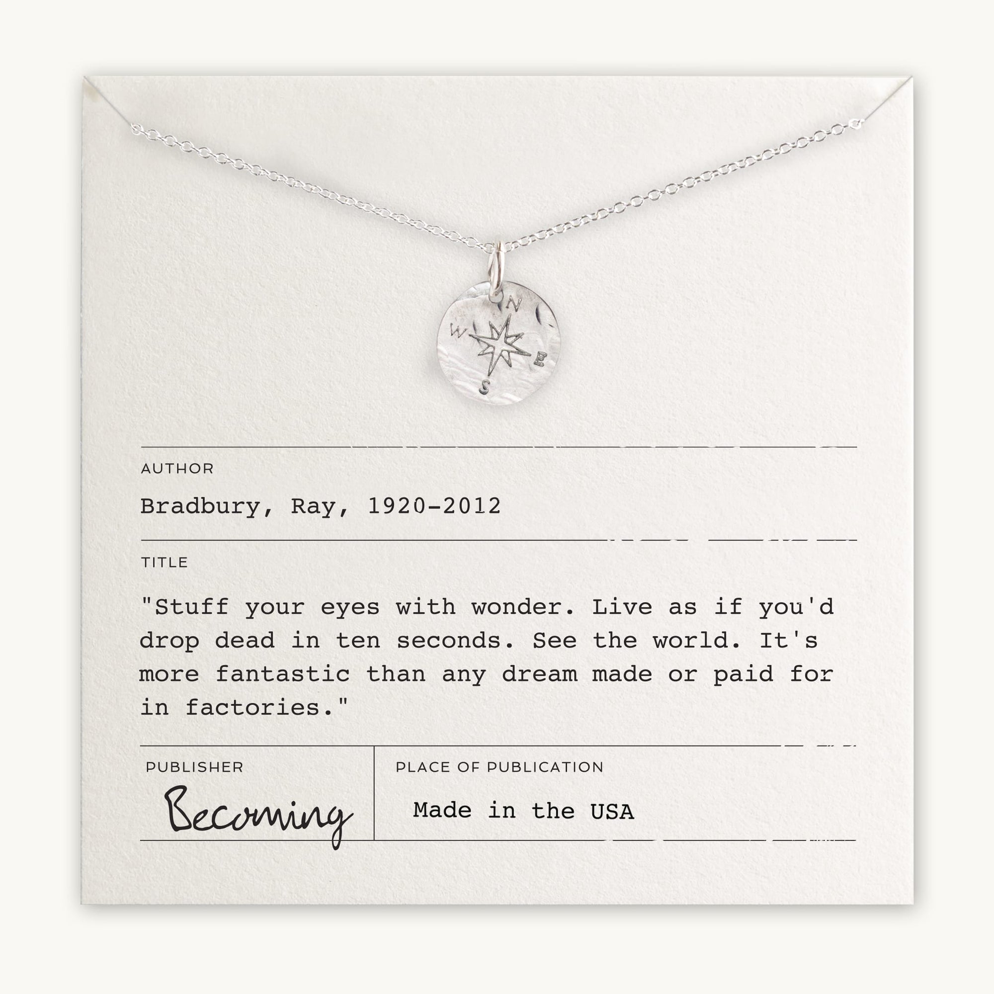 Becoming Jewelry&#39;s sterling silver Compass Necklace displayed on a card with an inspirational quote by Ray Bradbury.