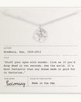 Becoming Jewelry's sterling silver Compass Necklace displayed on a card with an inspirational quote by Ray Bradbury.